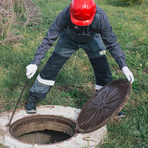plumber repairing a septic tank